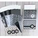 A card making to kit with black and white scrapbook paper, cardstock, flower embellishments, ribbons and cards and envelopes.